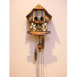 A mid 20th century Black Forest cuckoo clock, having musical carousel, with mechanical three