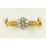 An Edwardian 18ct gold and diamond daisy cluster ring, L 1/2, 1.6gm