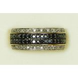 A 9ct gold black and white diamond set dress ring, P, 4.6gm