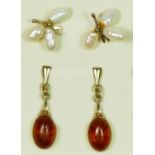 A 9ct gold mounted pair of amber ear rings, 12 x 8mm and a pearl pair of ear studs.