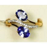 A 14ct gold, tanzanite and diamond dress ring, claw set with oval mixed cuts stones and brilliant
