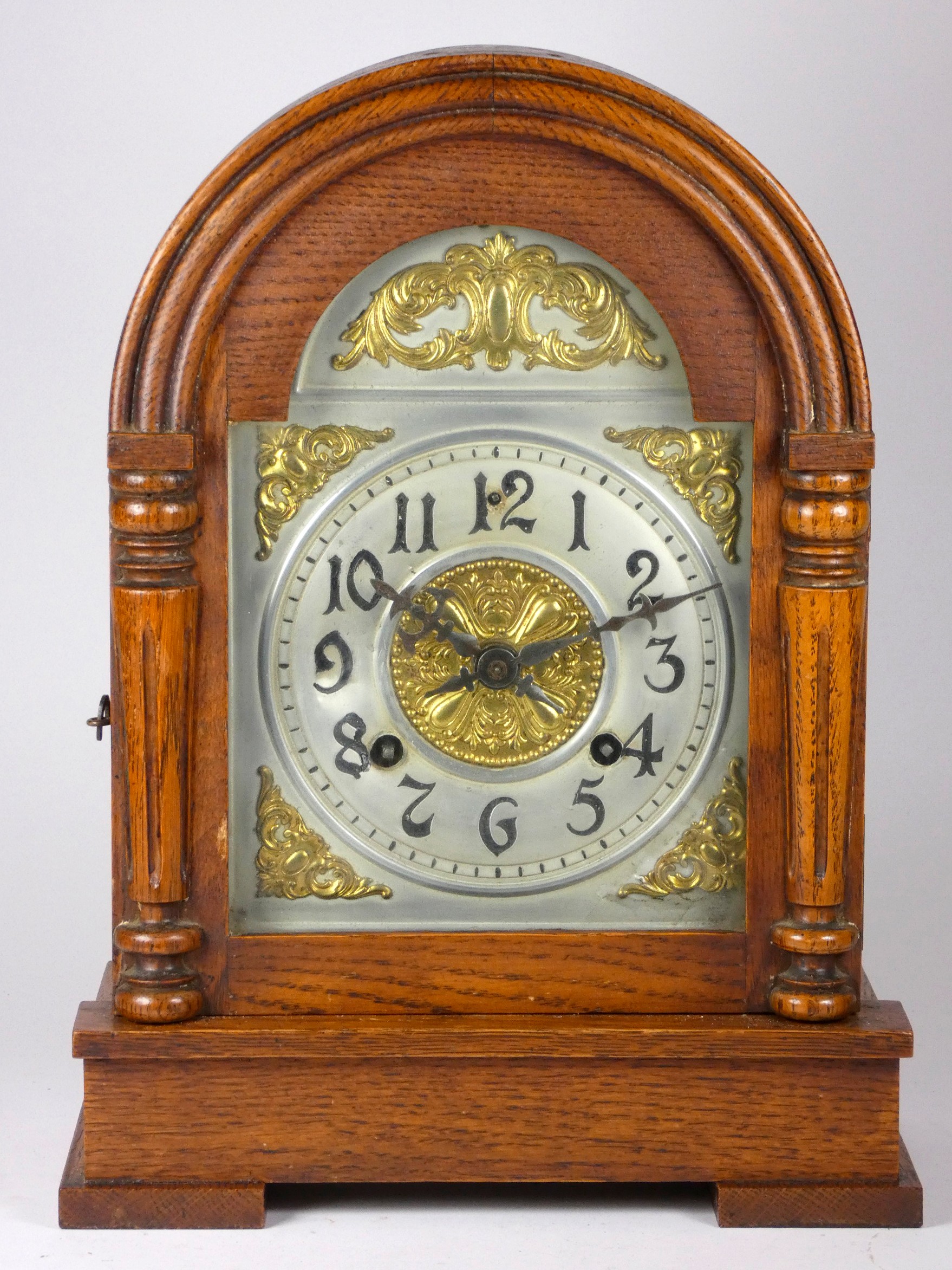 An early 20th century Asonia oak cased mantel clock, silvered chapter ring, dial with gilt