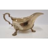 An Edwardian silver gravy boat, Sheffield 1903 with shell capped cast feet - 18cm, 253 grams.