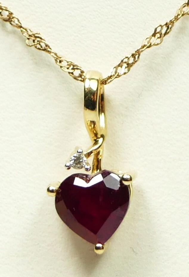 A 9ct gold heart shape ruby and brilliant cut diamond heart pendant, stone 7 x 7mm, 1.9gm