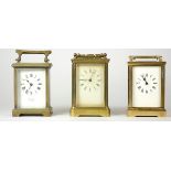 Three mid 20th Century carriage clocks, having 8 day movements, brass cased, enameled dials with