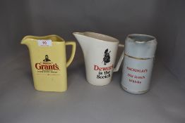 Three ceramic whisky or spirit decanters with advertising prints