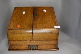 An Edwardian oak cased stationary box or storage tidy