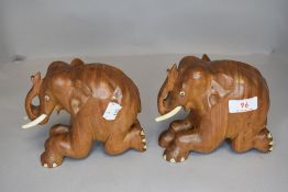 A pair of African carved wooden elephants