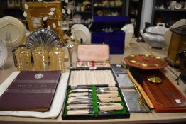 A selection of hardware including cutlery light shades and cigarette cases