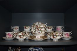 A selection of tea cups saucers and soup cups by Royal Albert in a various designs