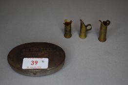 A small collection of WW1 Trench Art, a vase and two jugs made from bullet cases, one decorated with