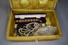 A seagrass sewing box containing a selection of costume jewellery including simulated pearls and