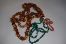 A long string of rough cut Baltic amber, string of branch coral and knotted string of green '