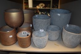 A selection of concrete cast plant pots and planters