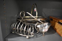 A small selection of silver plate including sauce boat, toast rack, table baskets etc