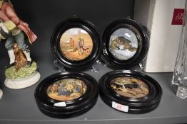 Four antique ceramic paste pot lids in ebonised frames