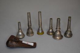 A selection of trumpet or brass instrument mouth pieces including Rudy Muck and Koolkup etc