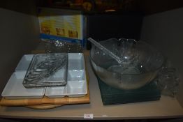 A selection of modern serving trays and party dishes including punch bowl