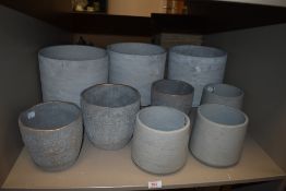 A selection of concrete cast stone effect planters and plant pots