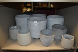 A selection of concrete cast stone effect planters and plant pots