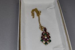 A vintage costume jewellery pendant and chain in Suffragette colours having paste purple, green