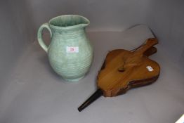 A pair of fire side bellows and an art deco water jug by Arthur Wood