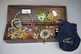 A lacquered box containing a selection of costume jewellery including Elvis Panther pendant,