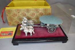 A model of a Chinese chariot and scroll