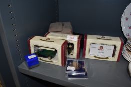 A selection of die cast model cars and commemorative coins