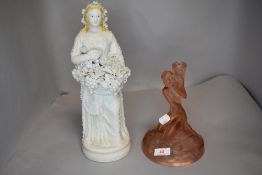 An art deco pink pressed glass lamp stand and a parian ware figure