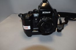 A Nikon F4 camera with Nikkor 28mm lens, pistol grip and connecting cable release