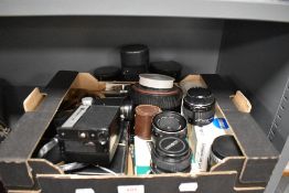 A box of photographic and film items including a Rank Aldis cine camera, a Carl Zeiss 135mm and 50mm