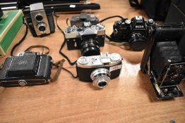 A selection of cameras including Brownie Reflex 20, Ricoh KR10, Regula, Houghton Butcher folding,