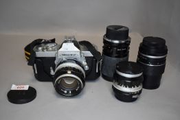 A Nikon Nikkormat N camera body with a Hansa 135mm lens, a Nikkor 35mm and 50mm lenses and a