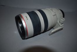 A Canon EF 100-400mm zoom lens, a Canon 75-300mm zoom lens in soft cover with original box, a Nikkor