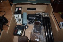 A box of photographic items including soft camera bag, tripod, splicer, Instamatic cameras,