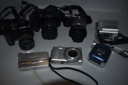 A selection of boxed digital cameras (with batteries and chargers) including Sony HD, Fine Pix HS30,