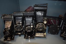 Nine folding cameras including Zeiss, Kodak, Voightlander etc