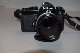 A Nikon FM camera with Nikkor 50mm lens