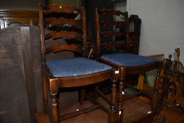 A pair of late C20th Ercol style ladder back dining chairs on turned legs