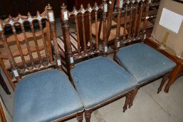 A set of three Victorian salon chairs having blue upholstery and painted detail