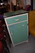 A vintage narrow cabinet, with drawer over cupboard