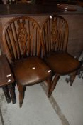 A pair og traditional dark stained wheelback chairs