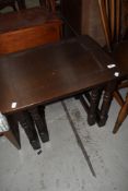 A mid Century part nest of two stained frame tables