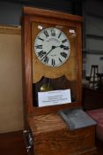 An early C20th, vintage oak frame clocking on/off clock