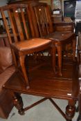 A mid C20th oak draw leaf dining table on bulbous legs, and two slat back dining chairs on slender