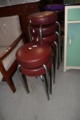 A set of six vintage chrome and vinyl low bar stools