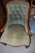 A Victorian low seat armchair having scroll arm and dralon upholstery with button back