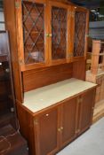 A Late C20th golden oak kitchen cabinet, having inset top with display over cupboards, w 135cm