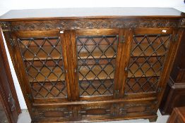 A late C20th dark oak Jacobean style bookcase, having leaded glass display, w 163cm